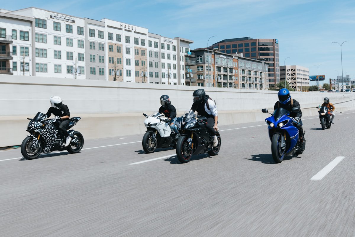 A group riding motorcycles down a street